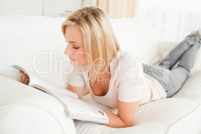 Blonde woman reading a magazine