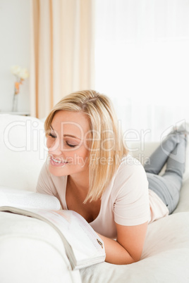 Blond-haired woman reading a magazine