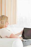 Portrait of a blonde woman using a notebook