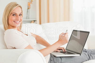 Cute woman paying her bills online