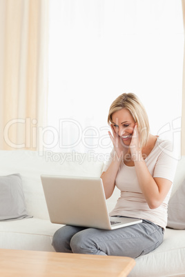 Portrait of a happy woman looking at her laptop