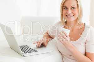 Close up of awoman holding a mug while with a notebook