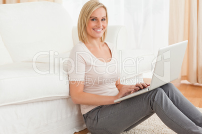 Portrait of a fair-haired woman with a laptop