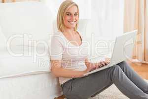Portrait of a fair-haired woman with a laptop