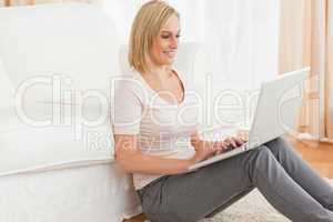 Portrait of a fair-haired woman using a laptop