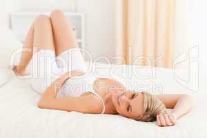 Charming woman posing on her bed