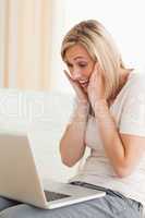 Delighted woman looking at a laptop