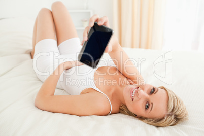 Cute woman showing her smartphone