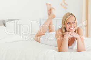 Smiling woman posing on her bed