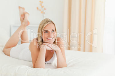 Serene woman posing on her bed