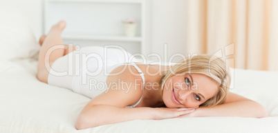 Serene woman lying on her bed