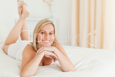 Close up of a serene woman lying on her bed