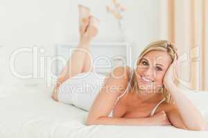 Calm woman lying on her bed