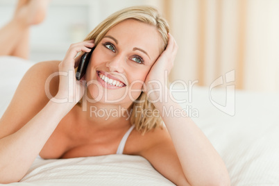 Close up of a smiling woman answering the phone