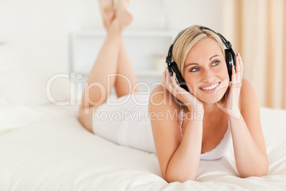 Cute woman listening to music in her bedroom