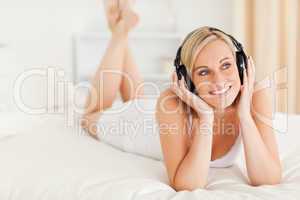 Cute woman listening to music in her bedroom