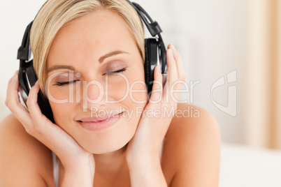 Close up of a delighted woman wearing headphones