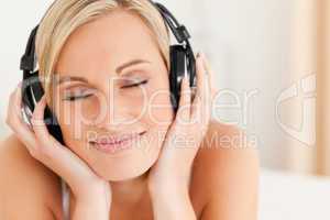 Close up of a delighted woman wearing headphones