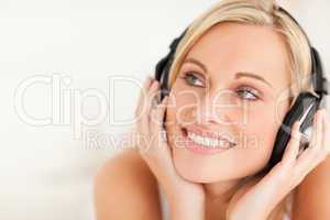 Close up of a smiling woman wearing headphones