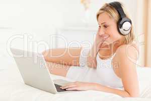 Woman watching movie while lying on her bed