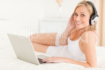 Woman watching movie while lying on her bed