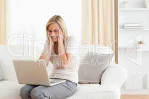 Upset woman using a laptop