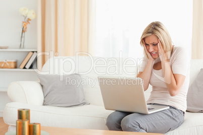 Close up of an upset woman using a laptop