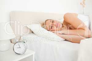 Woman sleeping and an alarm clock