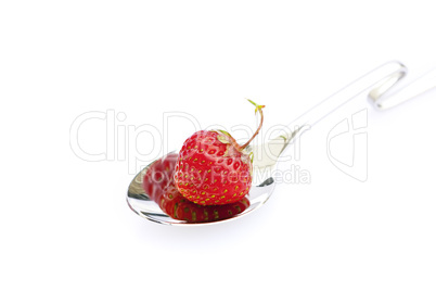 strawberry in a spoon isolated on white