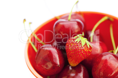 cherries and strawberries in a bowl isolated on white