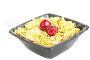 bowl of cornflakes cherry  and strawberry  isolated on white
