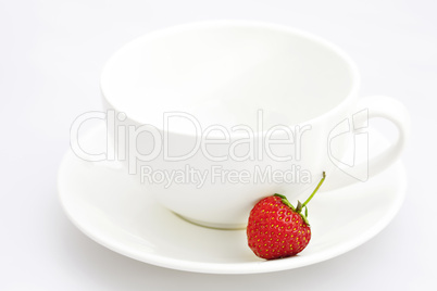 cup saucer and strawberries isolated on white cup saucer and strawberries isolated on white