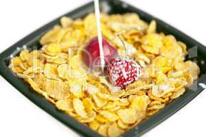 bowl of cornflakes milk  cherry  and strawberry  isolated on whi