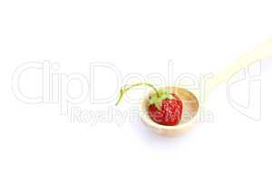 strawberry  in a wooden spoon isolated on white