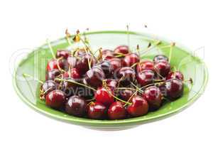 Cherries in a plate isolated on white