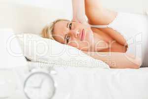 Unhappy woman awaked by her alarm clock