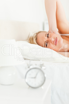 Portrait of a woman awaked by her alarm clock