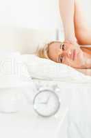 Portrait of a woman awaked by her alarm clock