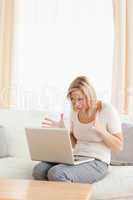 Potrait of an upset blonde woman using a laptop