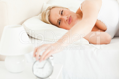 Upset blonde woman waking up