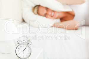 Angry blonde woman waking up