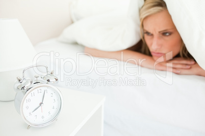 Displeased blonde woman waking up