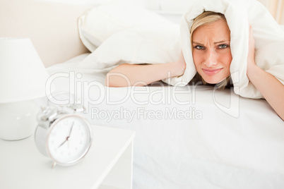 Disgruntled young woman waking up