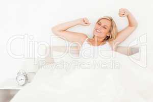 Blonde woman stretching her arms