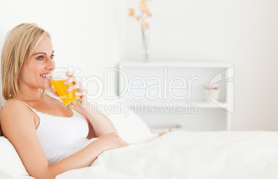 Blonde woman drinking juice