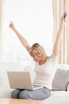 Portrait of a cheerful woman shopping online