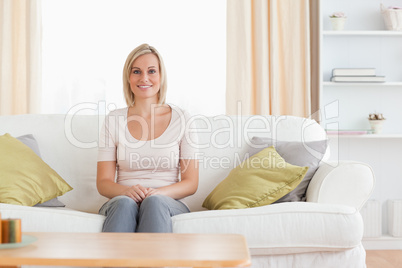 Cute woman sitting on a sofa