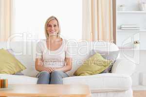 Cute woman sitting on a sofa
