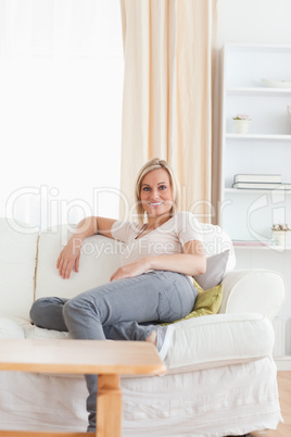 Portrait of a woman sitting on a sofa