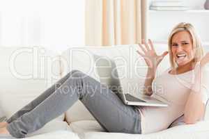 Unhappy blonde woman with a laptop